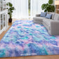 Multicolored shaggy rug in a living room with a sofa and plants.