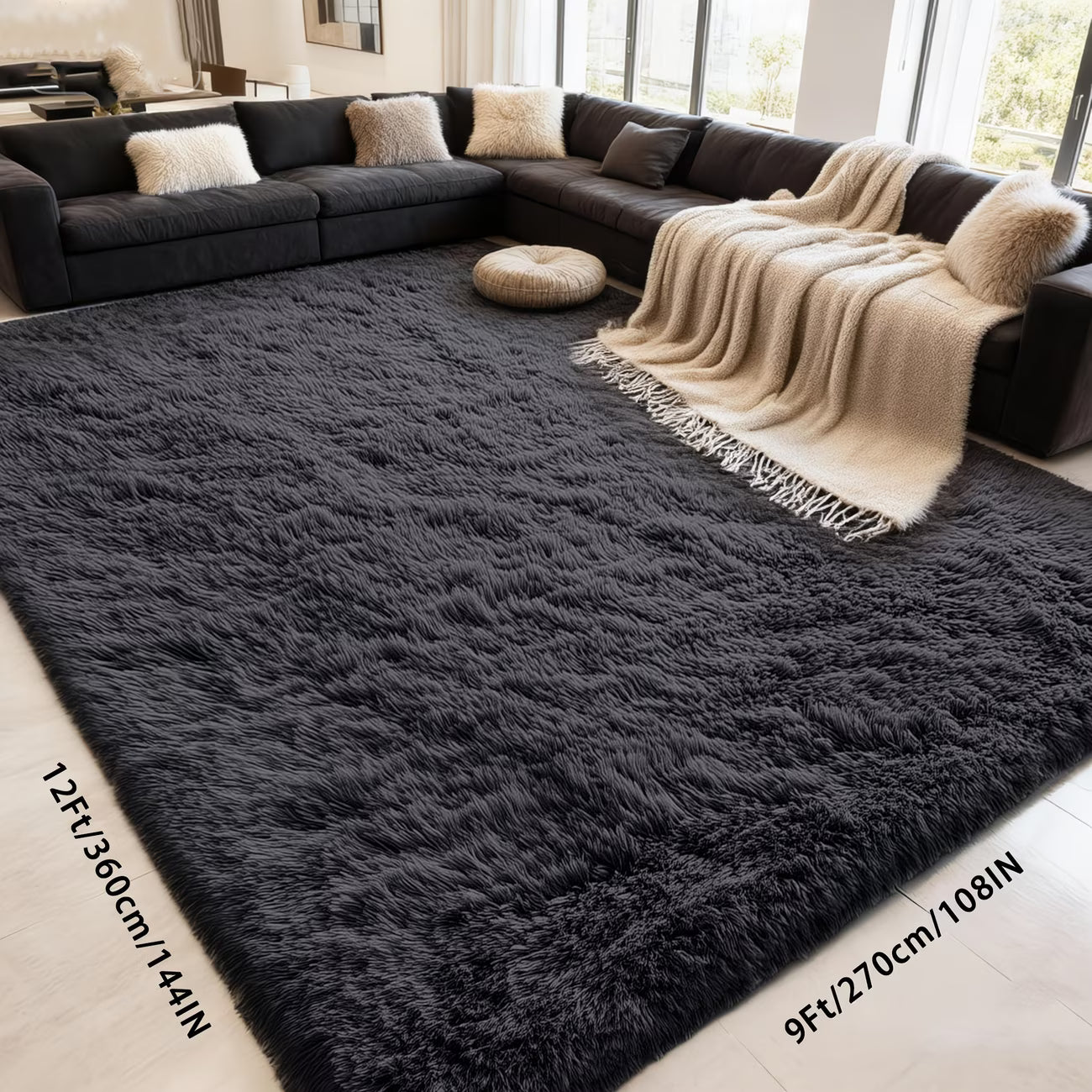 Large dark gray rug in a living room with a sectional sofa and decorative pillows.