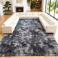 Gray shaggy rug in a living room with white sectional sofa and fireplace.