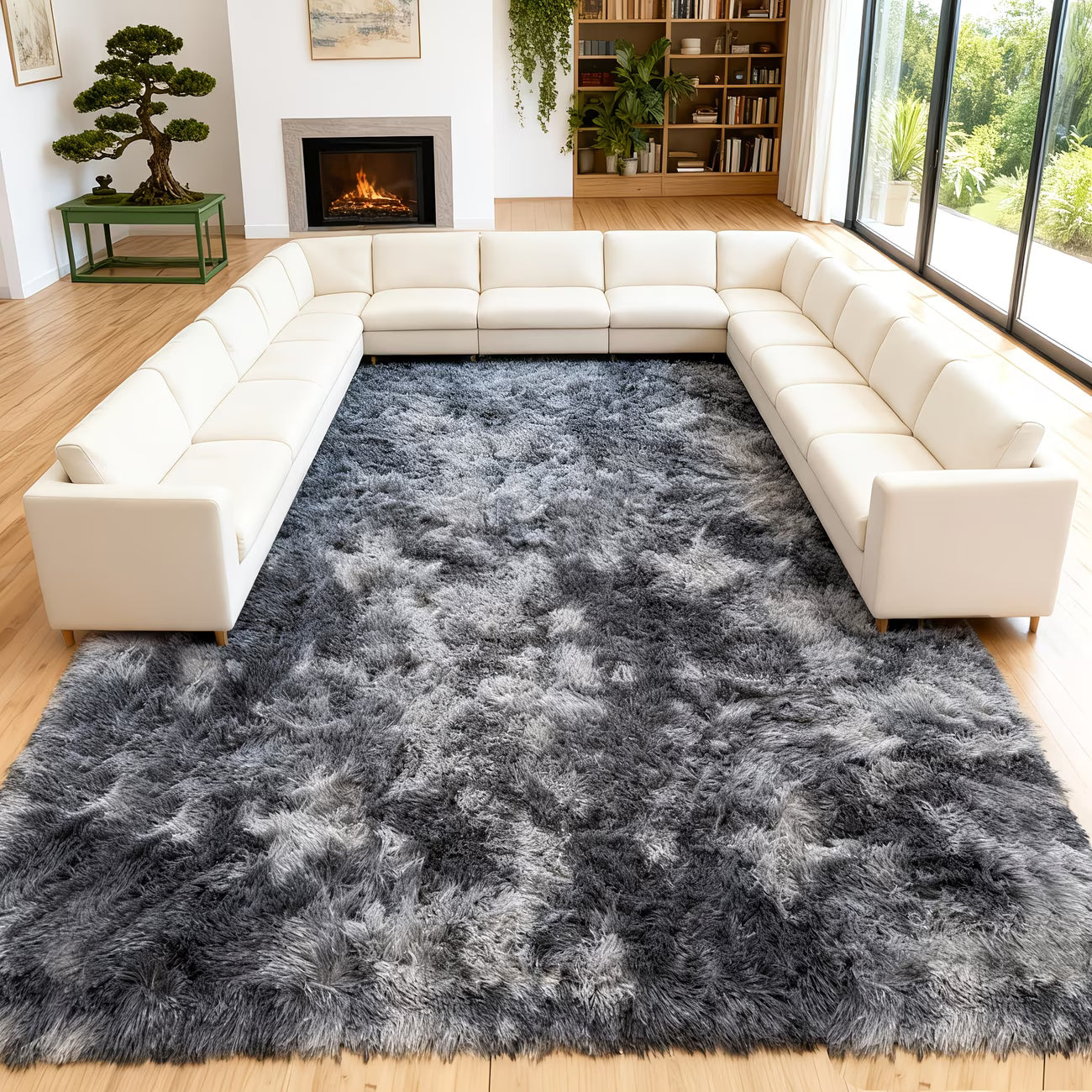 Gray shaggy rug in a living room with white sectional sofa and fireplace.