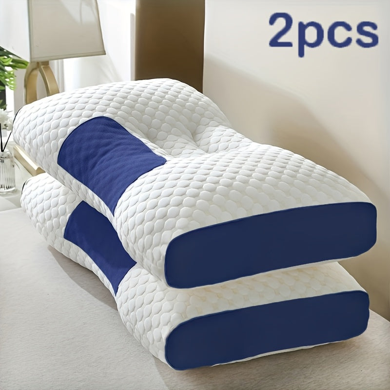 Two white and blue pillows on a bed in a bedroom setting.