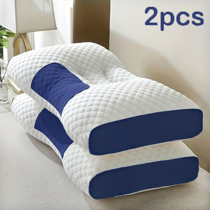 Two white and blue pillows on a bed in a bedroom setting.