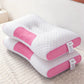 Pink and white pillow on a bed with a visible brand tag.