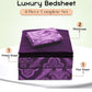 Purple paisley patterned bedsheet set with fitted sheet, flat sheet, and two pillowcases on a white background.