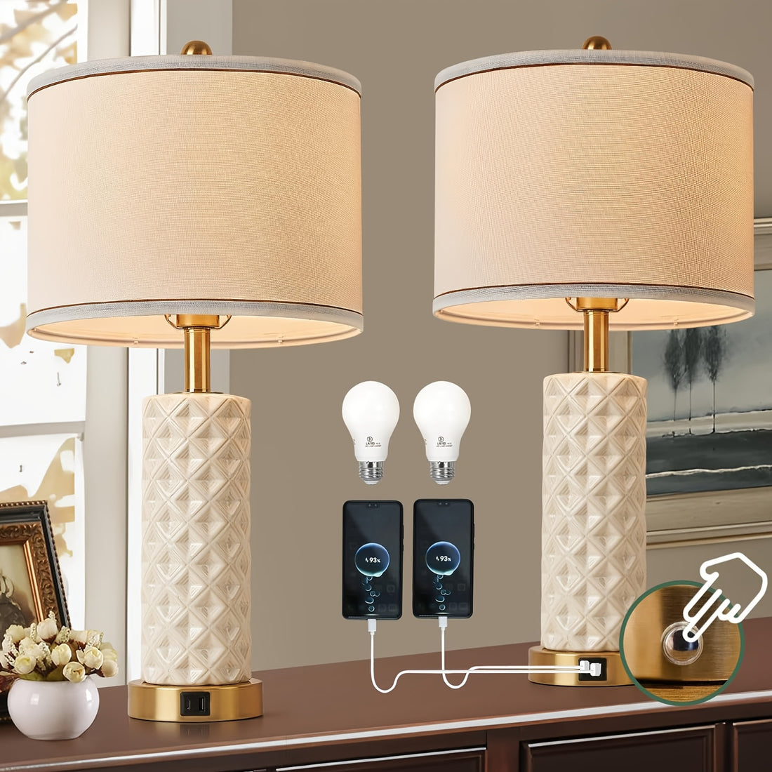 Two table lamps with beige lampshades and textured white bases on a wooden surface, with two light bulbs and a power adapter displayed.