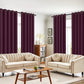 Living room with beige sofas, a wooden coffee table, and purple curtains.