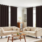 Living room with beige sofas, a wooden coffee table, and dark curtains.