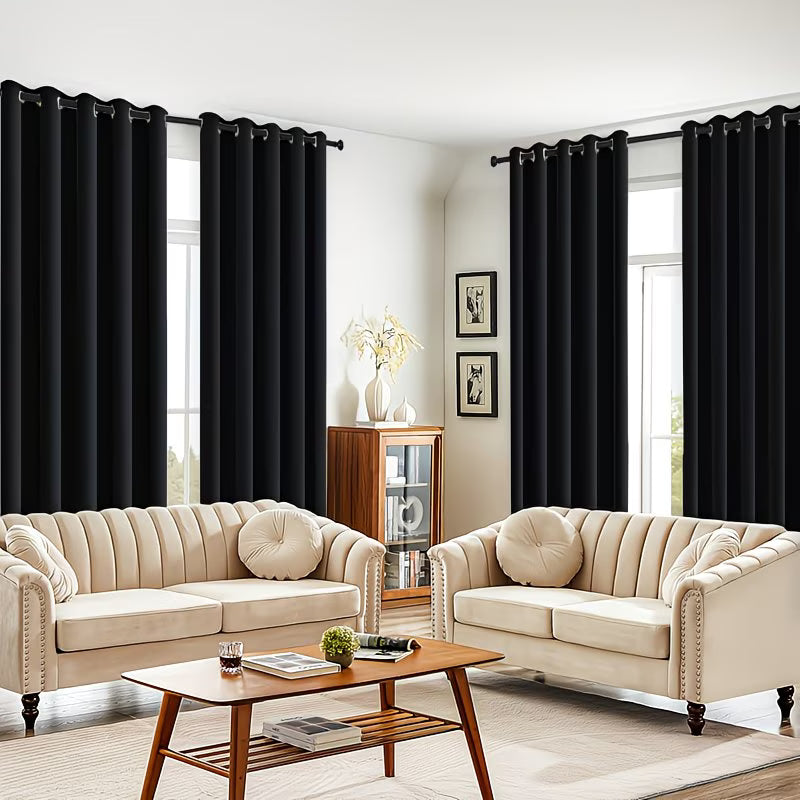 Living room with beige sofas, a wooden coffee table, and black curtains.