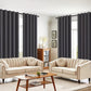Living room with beige sofas, a wooden coffee table, and dark curtains.