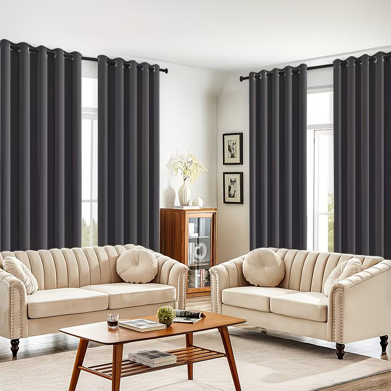 Living room with beige sofas, a wooden coffee table, and dark curtains.