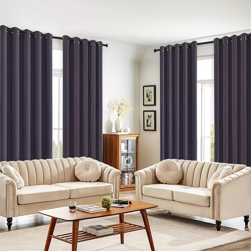Living room with beige sofas, a wooden coffee table, and dark purple curtains.