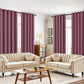 Living room with beige sofas, a coffee table, and purple curtains.