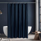 Navy blue shower curtain in a bathroom with a white bathtub and wooden stool.