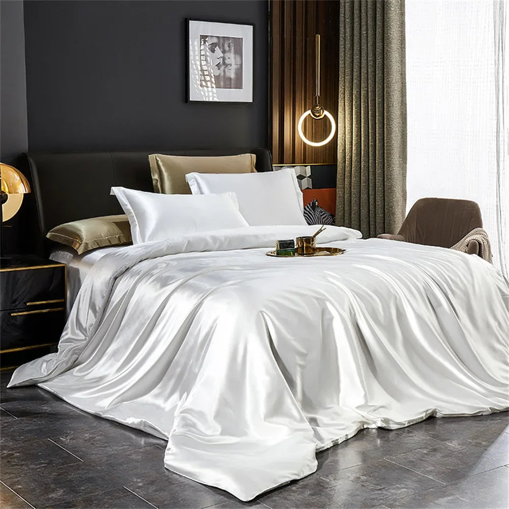 White satin bedding set on a bed in a stylish bedroom.