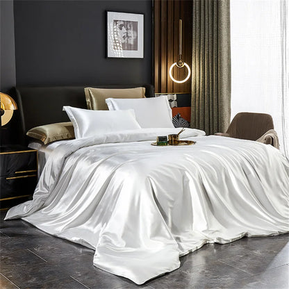 White satin bedding set on a bed in a stylish bedroom.