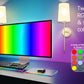 Computer monitor with RGB display, keyboard, and smartphone on a desk with colorful lighting effects.