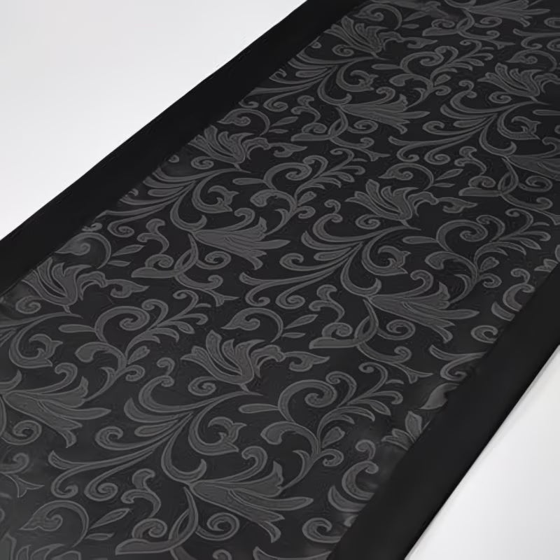 Black embossed patterned mat on a white background