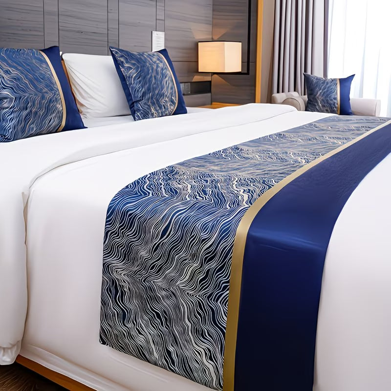Bed with decorative blue and gold bed runner and pillows in a bedroom setting.