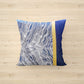 Decorative pillow with blue and white pattern on a wooden surface
