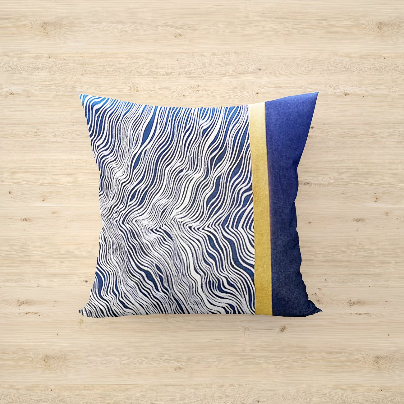 Decorative pillow with blue and white pattern on a wooden surface