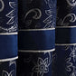 Close-up of blue fabric with white floral patterns