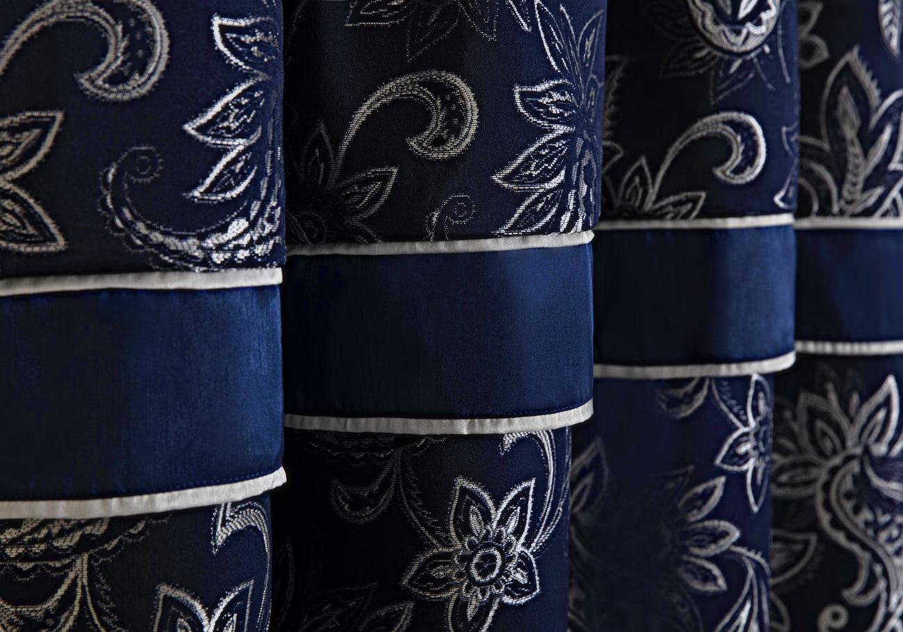 Close-up of blue fabric with white floral patterns
