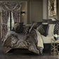 Luxurious bedroom with ornate bedding and decorative pillows.