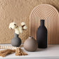 Set of ceramic vases on a neutral background with decorative elements.