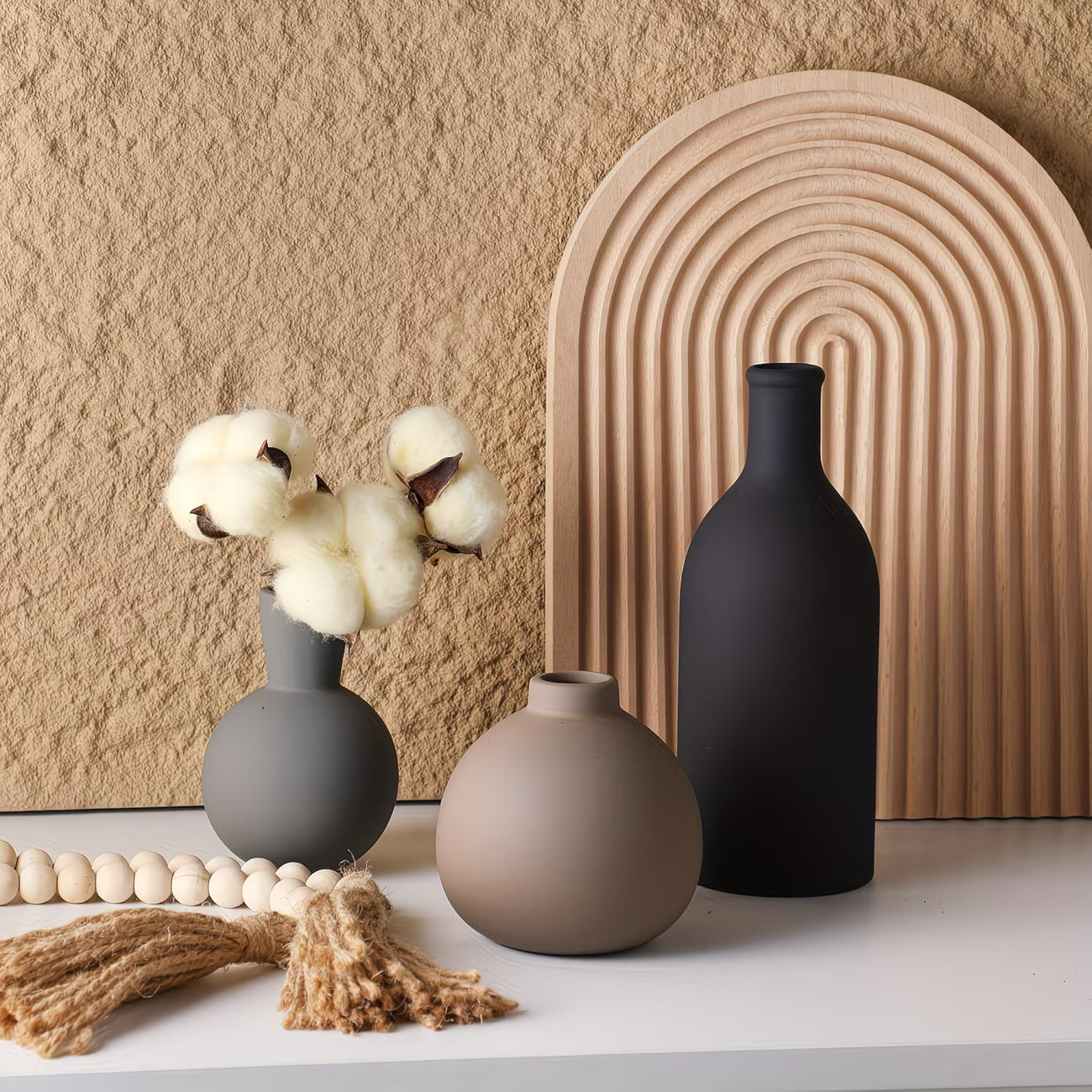 Set of ceramic vases on a neutral background with decorative elements.