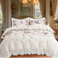 Floral bedding set on a bed in a decorated bedroom with curtains and a chandelier.