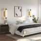 Modern bedroom with a bed, nightstands, and wall art.