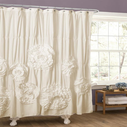 White floral-patterned shower curtain in a bathroom with a window and wooden side table.