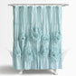 Light blue shower curtain with floral patterns on a white background