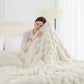 Woman wrapped in a fluffy white blanket in a cozy bedroom setting
