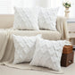 White textured pillows on a beige sofa with a neutral living room background
