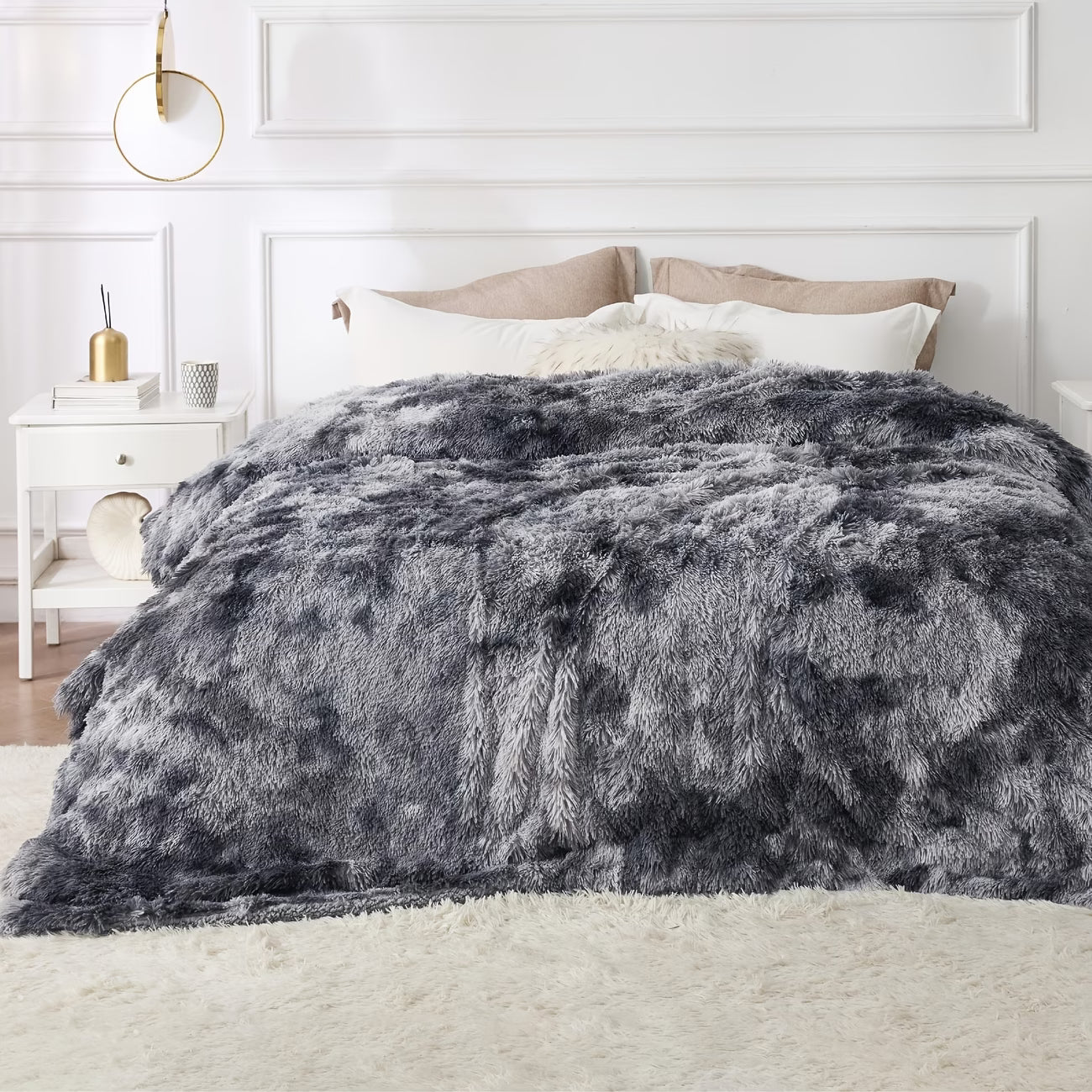 Gray fuzzy comforter on a bed in a bedroom setting