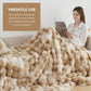 Woman reading a magazine under a large beige blanket in a cozy living room.