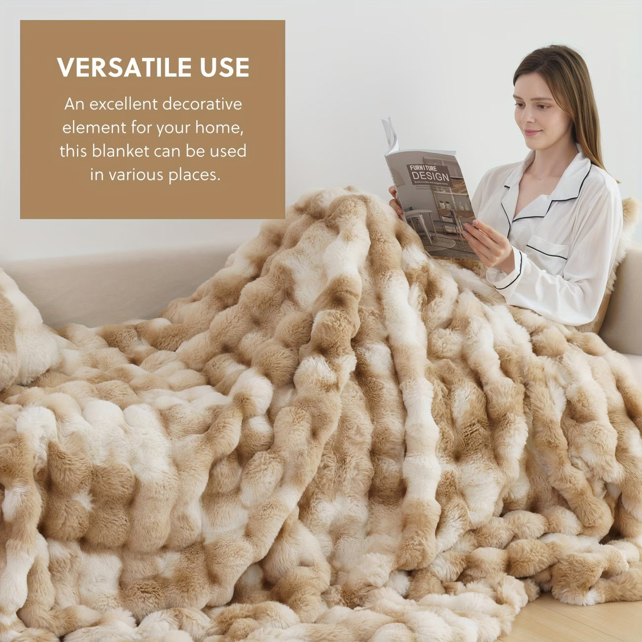 Woman reading a magazine under a large beige blanket in a cozy living room.