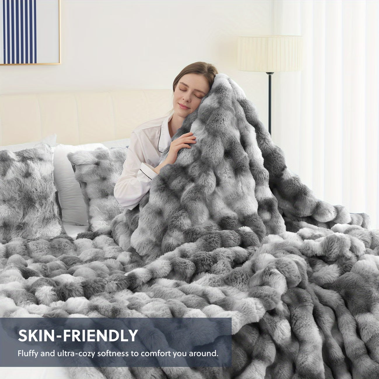 Person wrapped in a fluffy gray blanket in a cozy bedroom setting