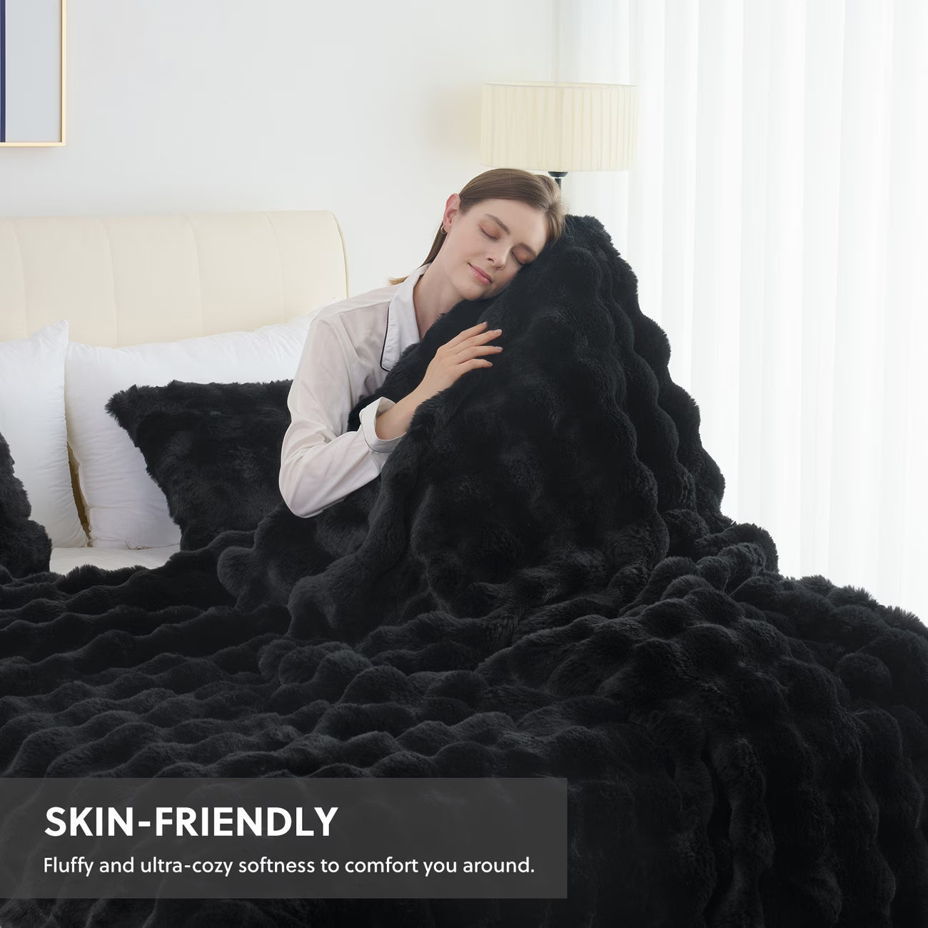 Woman wrapped in a black blanket in a bedroom setting with text 'SKIN-FRIENDLY'.