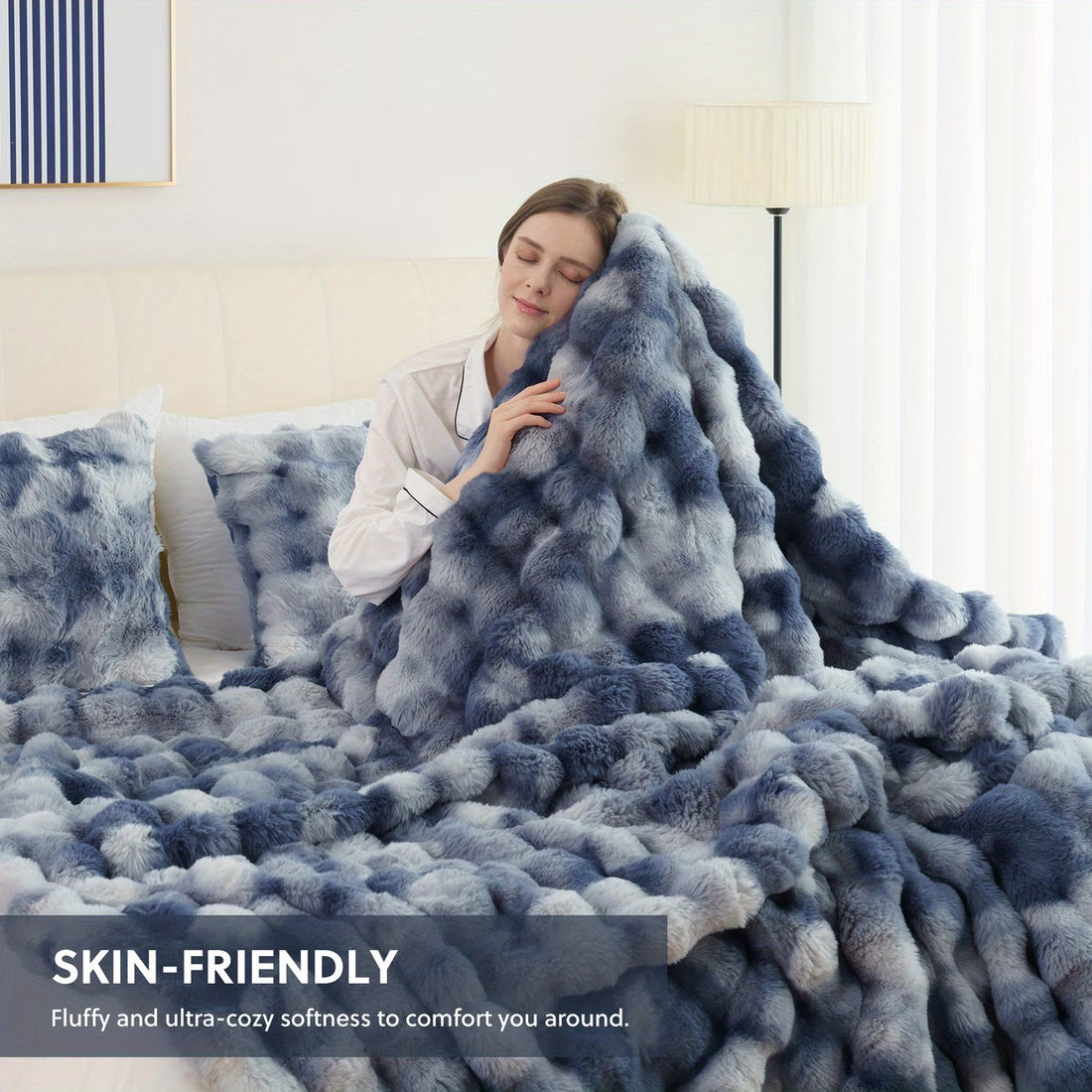 Person wrapped in a fluffy, blue blanket with text highlighting its skin-friendly and cozy qualities.