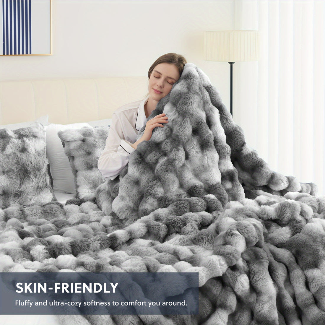 Person wrapped in a fluffy gray blanket in a cozy bedroom setting