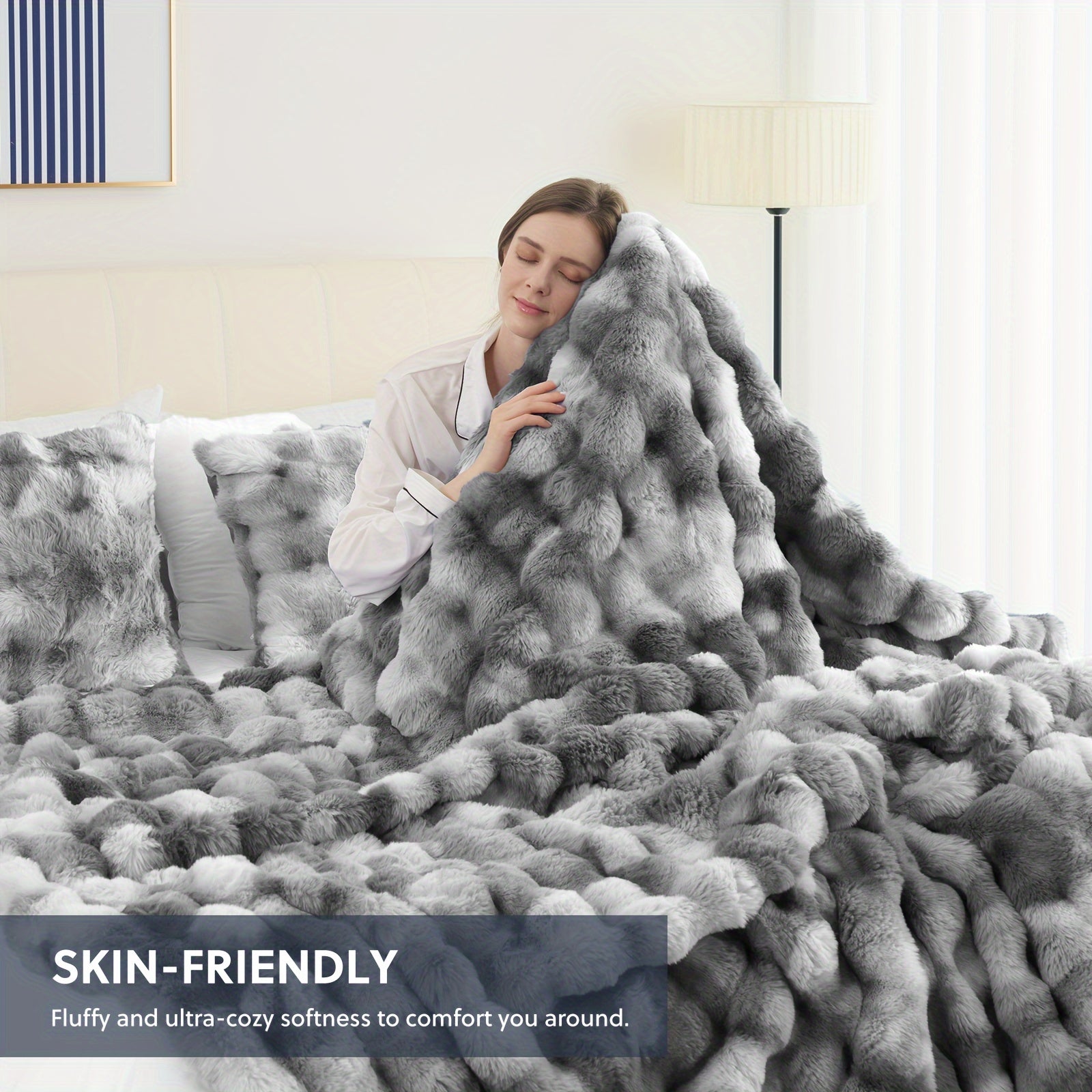 Person wrapped in a fluffy gray blanket in a cozy bedroom setting
