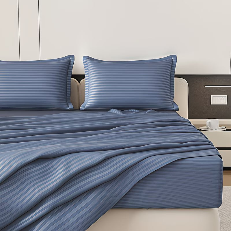 Blue striped bedding set on a bed in a bedroom setting.