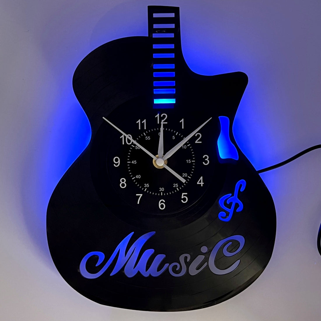 Guitar-shaped wall clock with blue LED lights on a white background