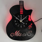 Guitar-shaped clock with 'Music' text and red LED lights on a white background