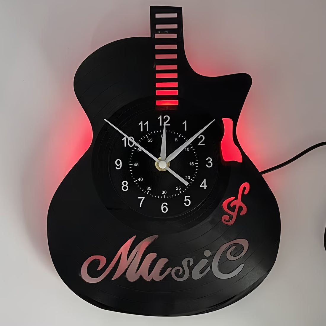 Guitar-shaped clock with 'Music' text and red LED lights on a white background