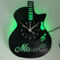 Guitar-shaped wall clock with green neon lights on a white background