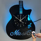 Guitar-shaped clock with LED lights and remote control on a gray background