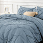 Blue textured comforter set on a bed 